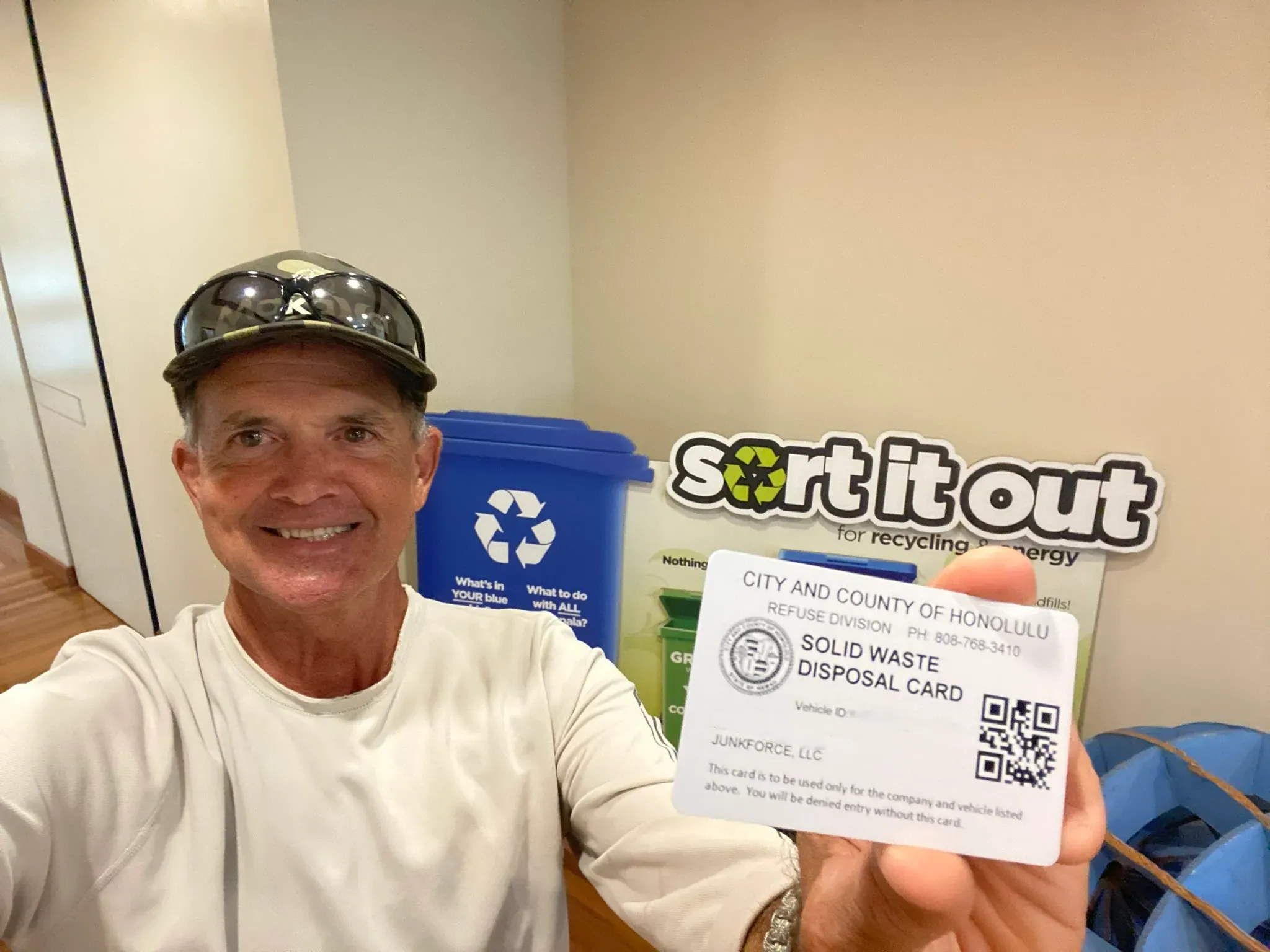 JunkForce team member holding Solid Waste Disposal Card